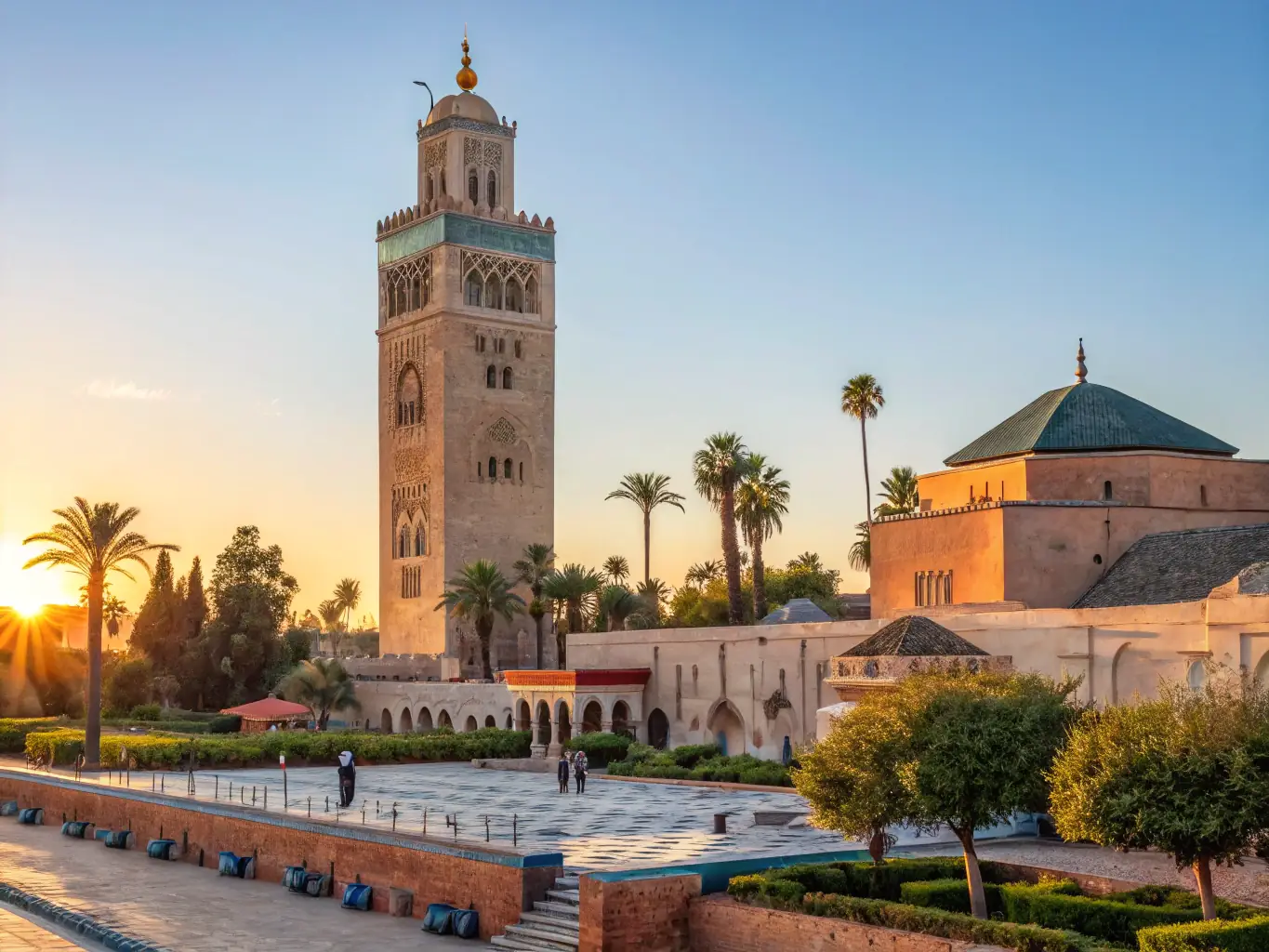 A vibrant, sunlit aerial view of Marrakech, showcasing its bustling medina, modern districts, and the Atlas Mountains in the background, symbolizing its blend of tradition and modernity as a prime real estate investment location.